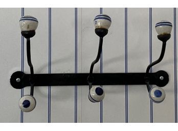 An Antique Wall Mount Iron,  Triple Hooks Coat Hanger With White And  Blue  Ceramic Knobs
