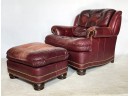 A Bespoke Oxblood Leather Armchair With Brass Nailhead Trim And Ottoman For Christman's Interiors Of Darien