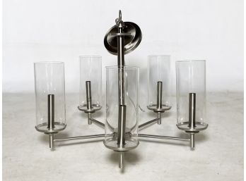 A Modern Chrome Chandelier With Glass Hurricanes