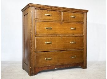 An Antique Paneled Oak Chest Of Drawers
