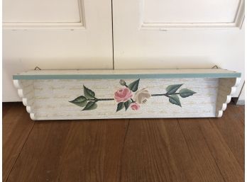 A Wall Hanging Shelf With A Rose Theme