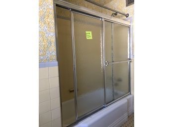 A Textured Glass Sliding Door Tub Enclosure With Chrome Tone Hardware - Yellow Bath