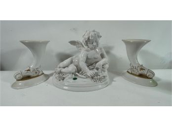 A LARGE ITALIAN PORCELAIN CUPID SCULPTURE WITH TWO CORNUCOPIA VASES, 11' X 10' AND 8' TALL VASES