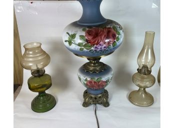 A GWTW PAINTED OIL LAMP AND TWO OTHER OIL LAMPS