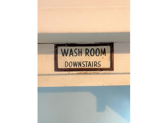 A Framed 'wash Room Downstairs Sign'