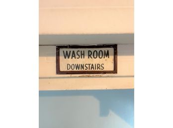 A Framed 'wash Room Downstairs Sign'