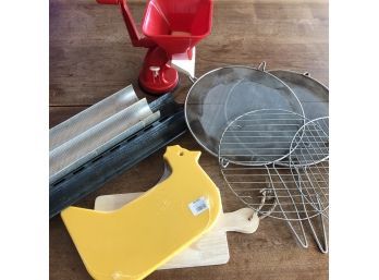 A Collection Of Kitchen Equipment Including Tomato Mill And French Bread Pans