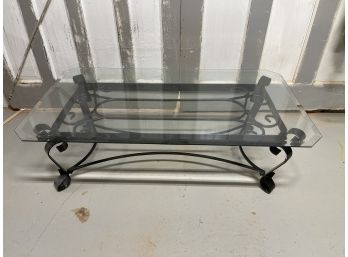 Beveled Glass Coffee Table On A Black Metal Base