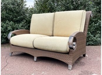 A Metal And Resin Loveseat By Cast Classics