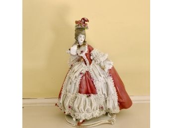 An Intricate Porcelain Figurine With Delicate Lace