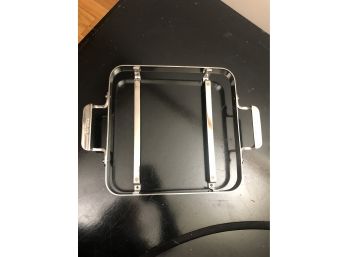 An 11' All Clad Stainless Steel Dish Holder