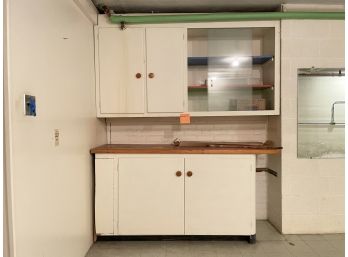 A Lower Wood Base Unit With Upper Cabinet And Laboratory Style Glass Sliding Doors
