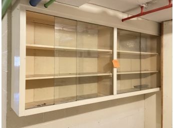 A Wood Laboratory Style Cabinet With Glass Sliding Doors