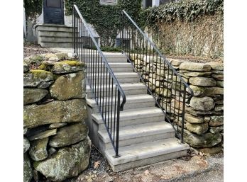 A Set Of Pre-cast Concrete Steps With Wrought Iron Railings