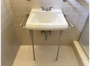 An American Standard MCM Sink With Towel Bars, Basement