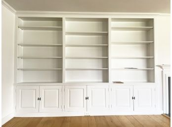 A Custom Wood Built In Shelving Unit With Cabinets