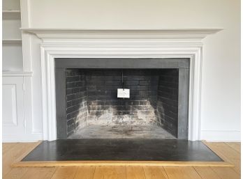 A Wood Fireplace Mantle, Surround And Stone Hearth