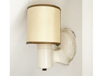 A Ceramic Wall Sconce With Shade