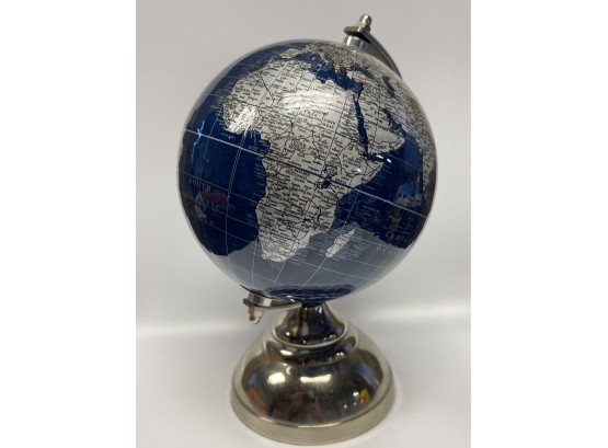 A Small Globe With A Silver Toned Plastic Base