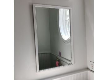 A Wood Framed Beveled Mirror