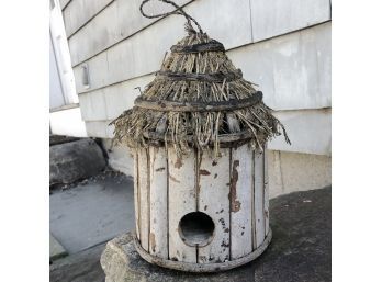 A Thatched Roof Circular Bird House