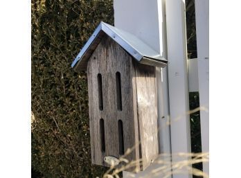 A Birdhouse With Metal Roof