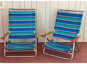A Pair Of Striped Folding Beach Chairs