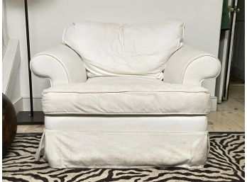A Slip Covered Chair By Pottery Barn
