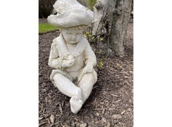 An Outdoor Figurine Of A Young Lady In A Hat
