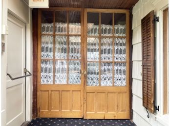 A Pair Of Antique Paneled Pine French Doors
