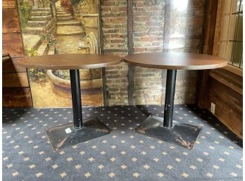 A Pair Of Round Cafe Tables With Rectangular Bases