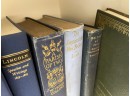 Two Shelves Of Vintage Hard Bound Books In Shades Of Blue And Grey