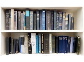 Two Shelves Of Vintage Hard Bound Books In Shades Of Blue And Grey