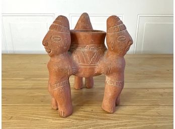 Clay Sculpture Of Men Holding Vessel