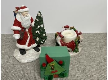 A Ceramic Santa Statue With A Xmas Candle Holder