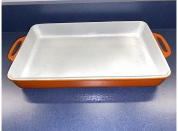 Cast Iron Enamel Lasagna Casserole Pan With Handles. Burnt Orange And White. Measures 8 3/4' X 14 3/4'.