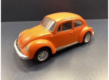 Vintage Orange Plastic Volkswagen Beetle Toy Car.