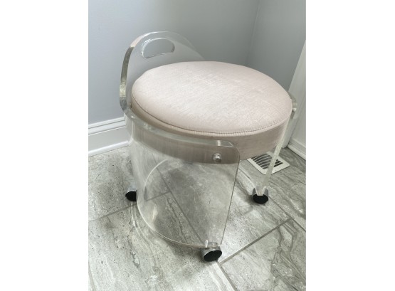 A Lucite Round Vanity Bench On Wheels With Cushion