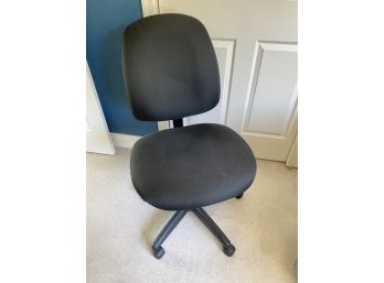 An Adjustable Black Desk Chair On Wheels