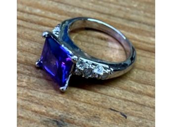 Very Cool Fashion Cocktail Ring With Purple Center Stone Flanked By Rhinestones
