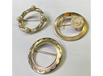THREE DIFFERENT GOLD TONE CIRCLE PINS