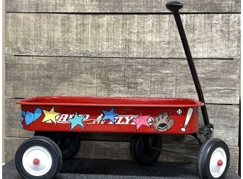 A Mini Radio Flyer With Hand Painted Images Including The Name George