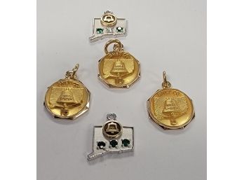 3 10K CHARMS AND 2 14K CHARMS WITH EMERALDS AND A DIAMOND (SOUTHERN NEW ENGLAND TELE. YEARS OF SERVICE CHARMS