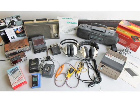Vintage Electronics Lot With Boom Box, Alarm Clocks, Headphones, Sony Walkman's, Battery Charger & More