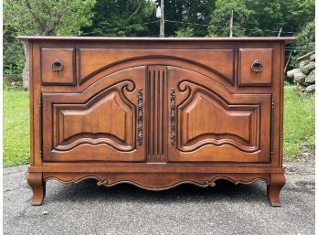 A Paneled Cherry Wood Commode In French Provincial Style