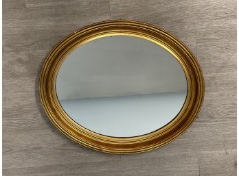 A Vintage Oval Mirror In A Gilt Wood Frame