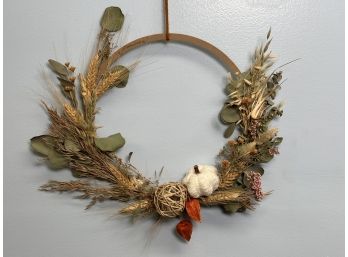A Wood Wreath Form With Autumnal Decoration