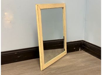 A Simple Beveled Wall Mirror In A Distressed Wood Frame