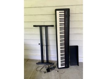 A Roland FP-30 Electronic Keyboard With Stand