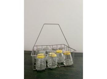 A Vintage Wire Milk Bottle Carrier With Glass Jars